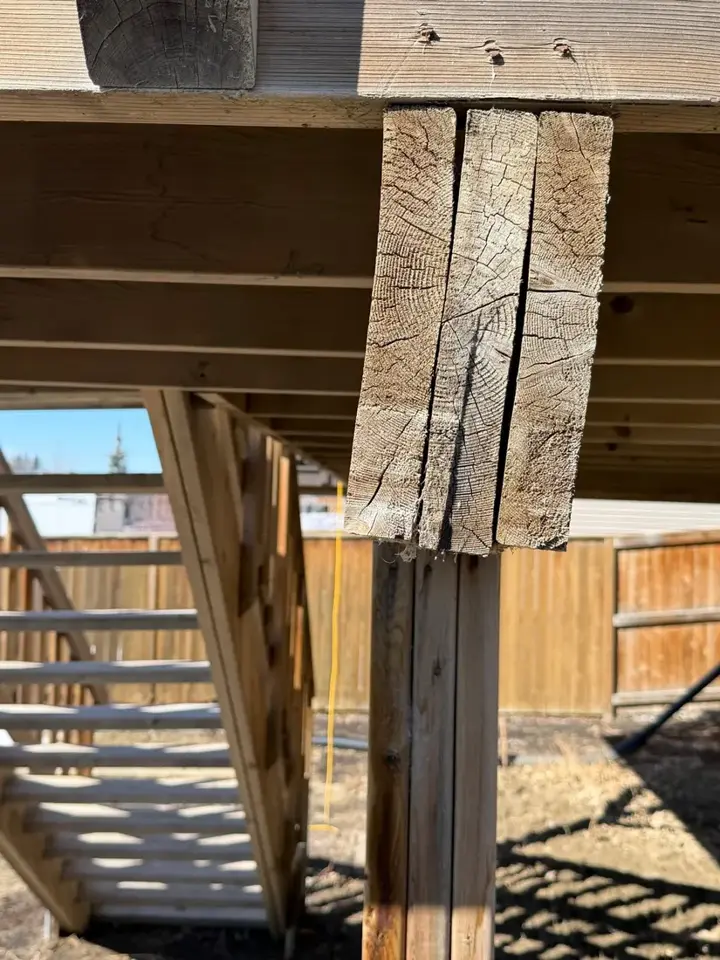 Deck support post split and checked through the end grain, Central Alberta