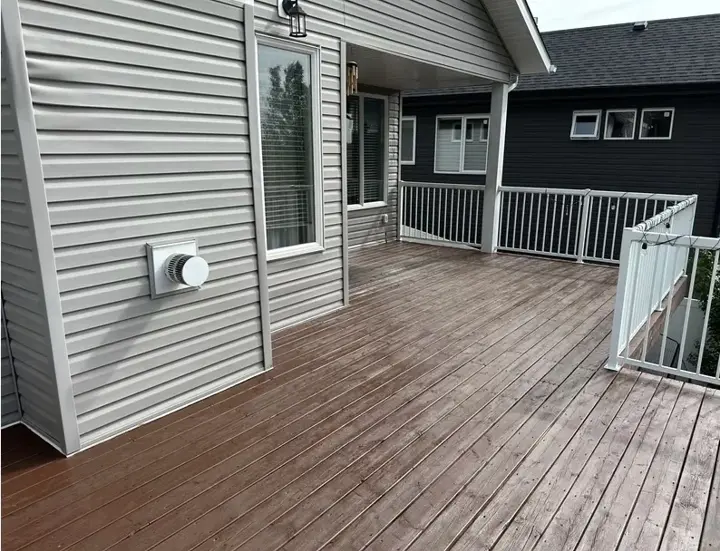Refinished pressure treated deck with fresh stain in Red Deer, Alberta, restored by Green Ladder Contractors