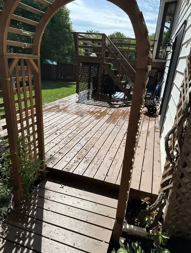 Weathered deck with peeling and flaking stain before restoration by Green Ladder Contractors in Red Deer