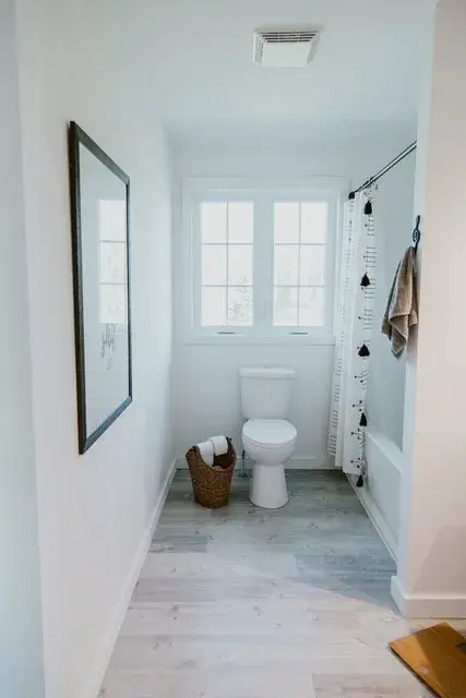 Expanded upstairs bathroom with new tub and shower surround and laminate flooring in Red Deer, AB - renovated by Green Ladder Contractors