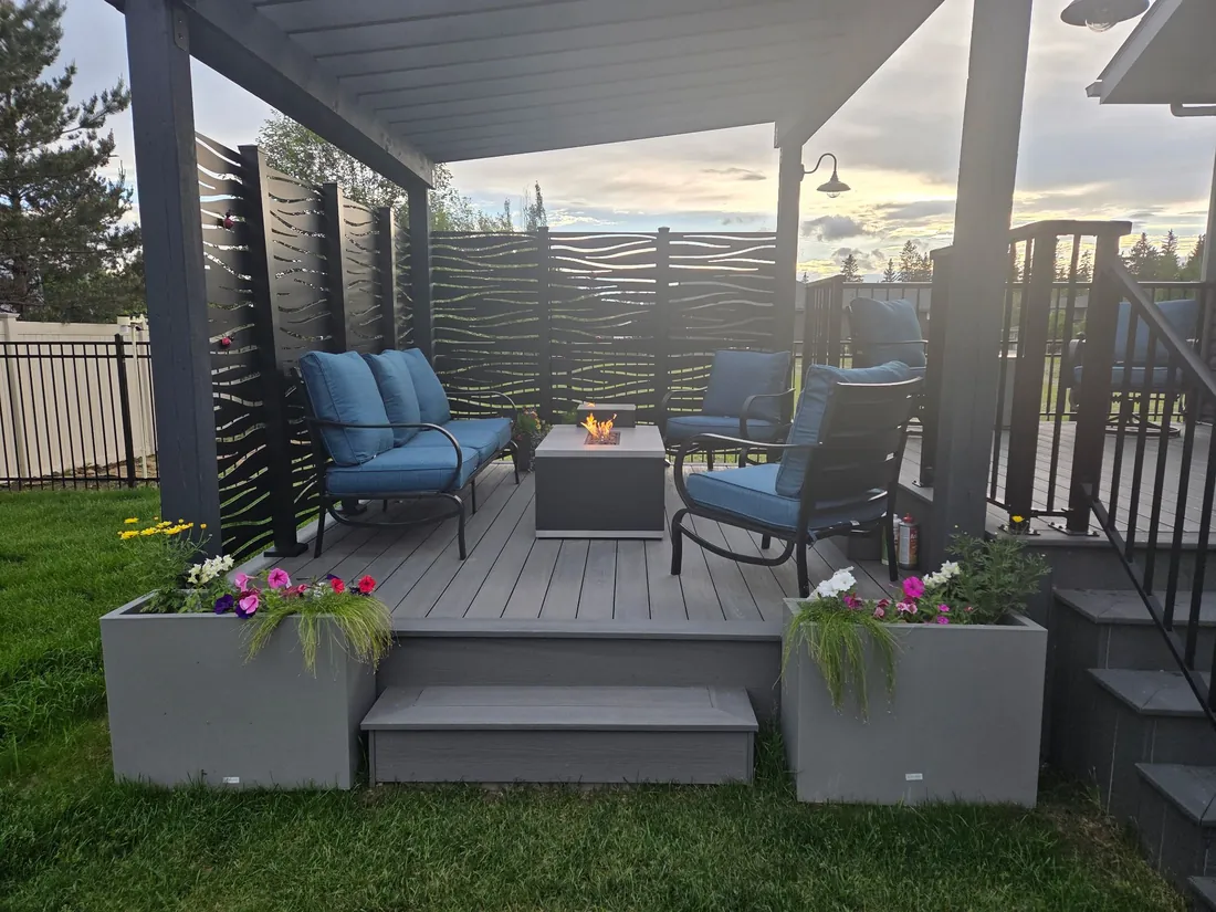 Custom pressure treated pergola with Sunbelly aluminum privacy screens over a TimberTech Prime+ composite deck in Red Deer, AB - built by Green Ladder Contractors